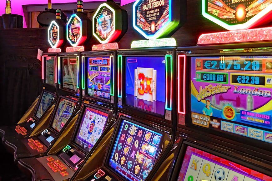 Row of illuminated slot machines in a casino