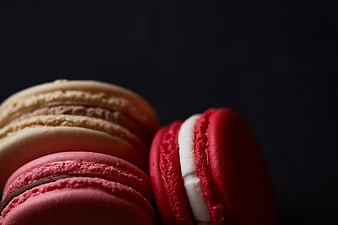 Close-up of colorful macarons on dark background