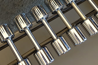 Chrome dumbbells on rack in gym