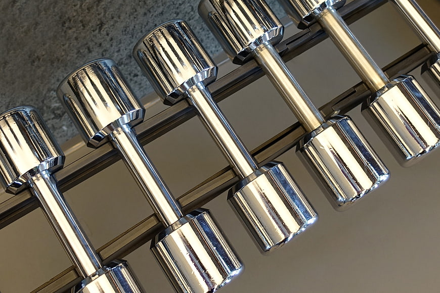 Chrome dumbbells on rack in gym