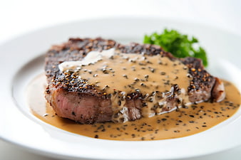 Juicy Steak Au Poivre with Creamy Sauce on White Plate