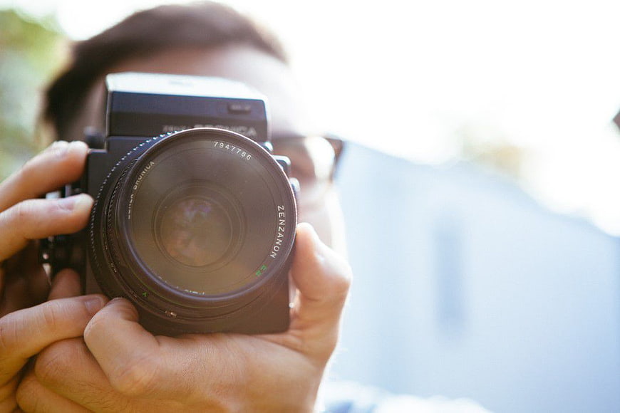 Close-up of Photographer Holding Vintage Camera Lens