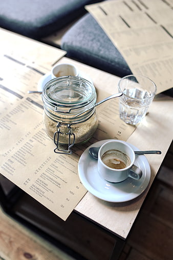Empty espresso cup and sugar jar on cafe menu