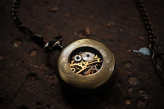 Vintage Brass Pocket Watch with Exposed Gears on Wood