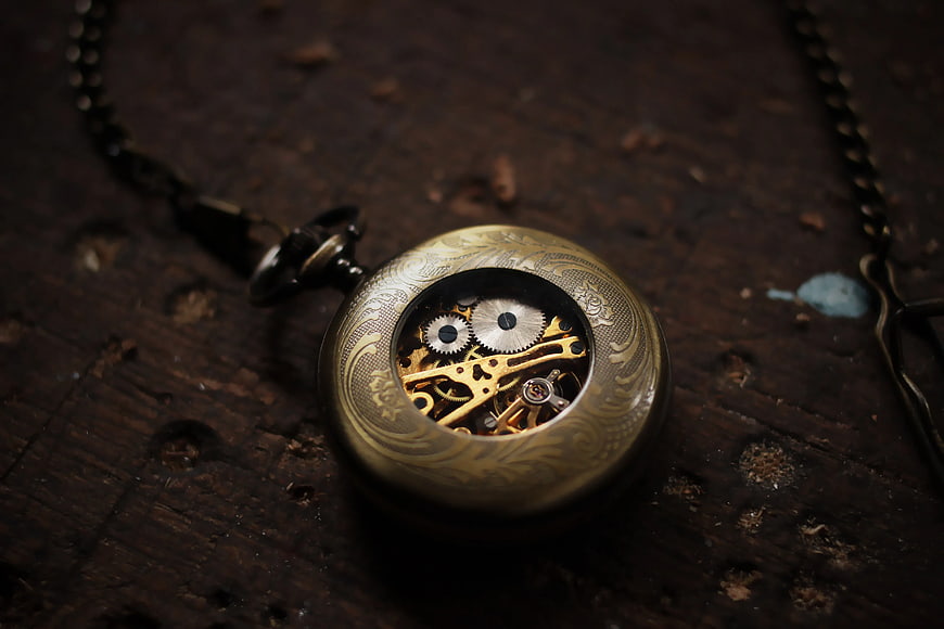 Vintage Brass Pocket Watch with Exposed Gears on Wood