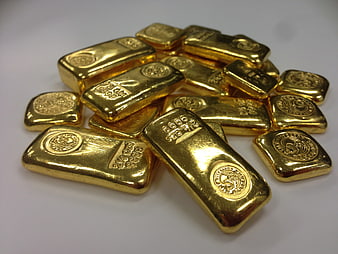 Pile of shiny gold bars on white background
