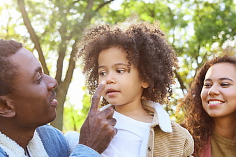 Happy African American Family Playing Outdoors in Park