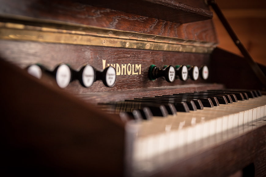 Close-up of vintage Lindholm harmonium keyboard and stops