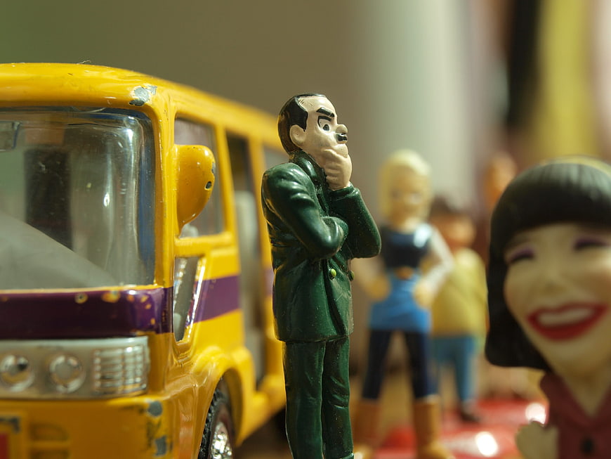 Close-up of Monty Python toy figures with yellow bus