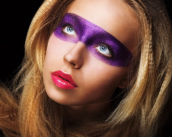 Woman with purple glitter mask makeup and pink lips