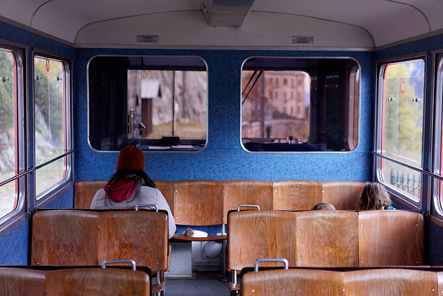 Interior of a vintage train carriage with passengers