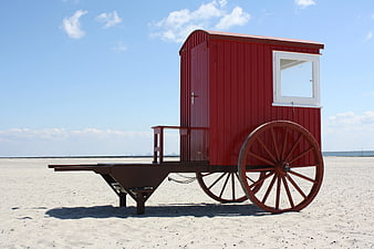 Red Vintage Beach Cart on Sandy Shore