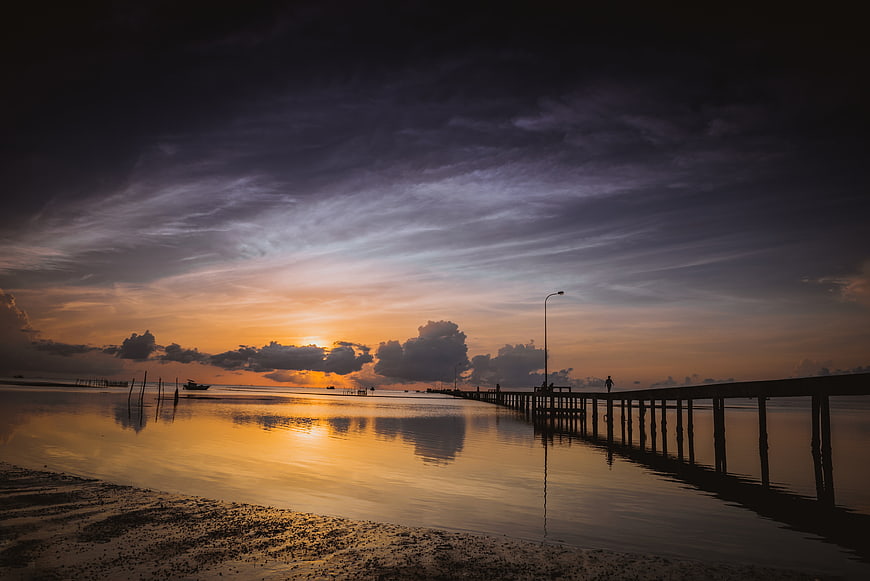 Dramatic Sunrise Over Wooden Pier in Vietnam Seascape
