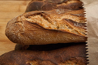 Rustic French Bread Loaves on Wooden Surface