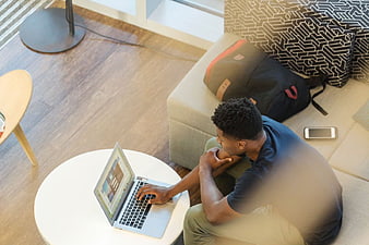 High Angle View of Man Working on Laptop on Couch