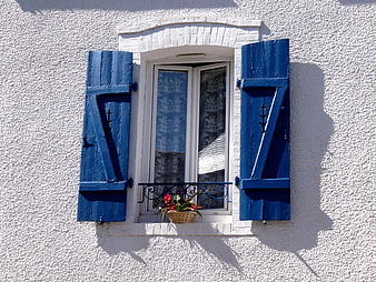 Blue Wooden Shutters on White Wall with Flower Box