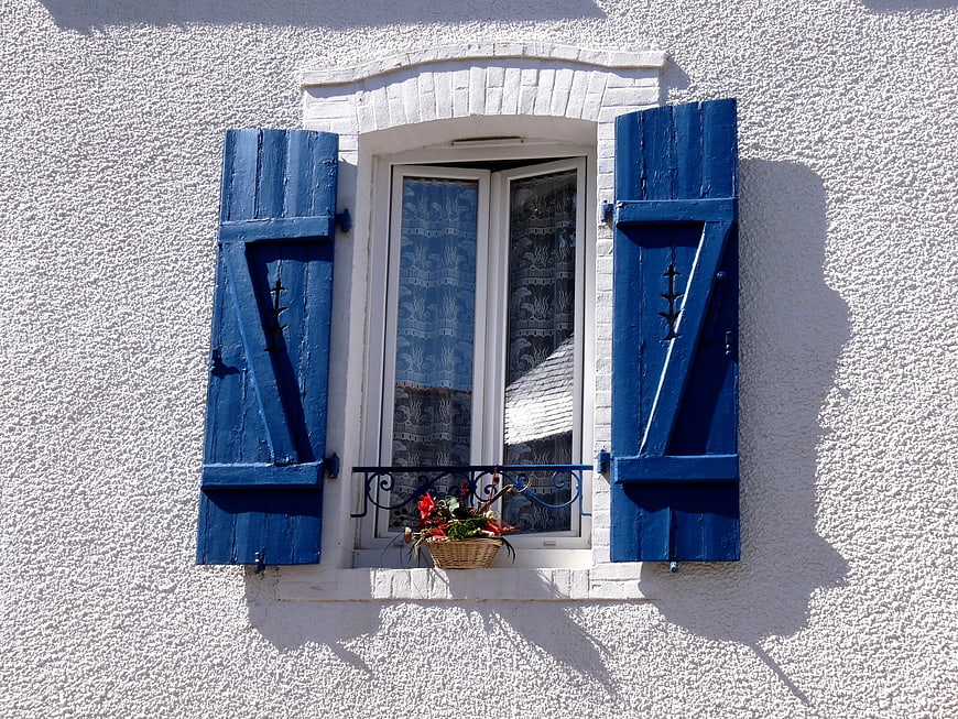 Blue Wooden Shutters on White Wall with Flower Box