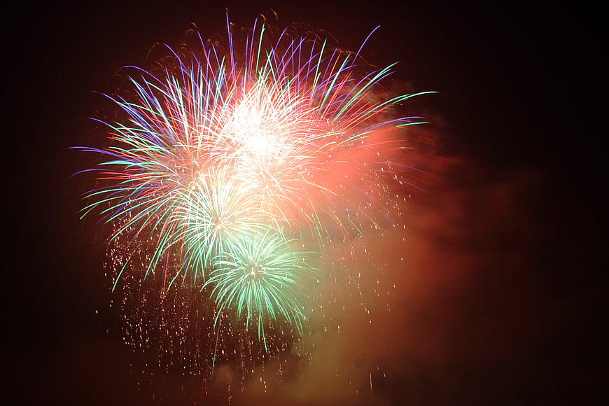 Colorful Fireworks Bursting In Dark Night Sky