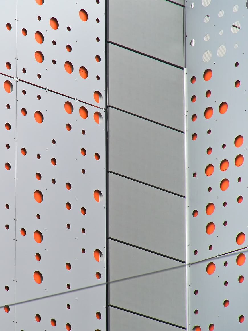 Modern Perforated Metal Wall with Orange Accents
