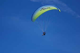 Paragliding Duo Soaring in Clear Blue Sky