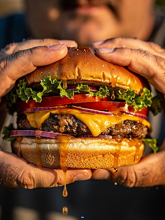 Close-up of Juicy Cheeseburger with Dripping BBQ Sauce