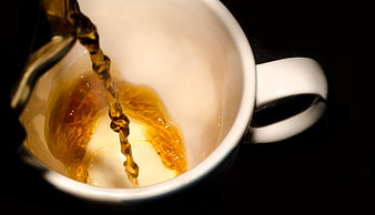 Pouring Hot Coffee into White Ceramic Cup