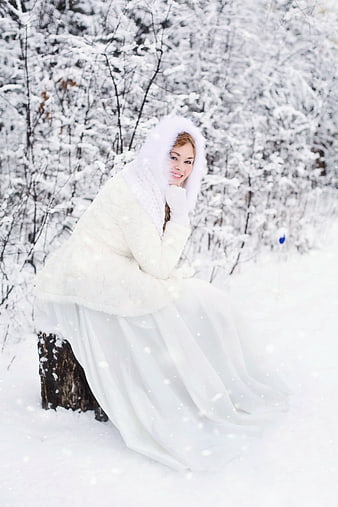 Woman in White Fur Hooded Dress in Snowy Forest