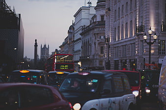 London Traffic with Red Double-Decker Bus at Dusk