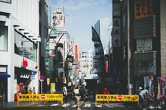 Busy Japanese Street Scene with Cyclists and Shops