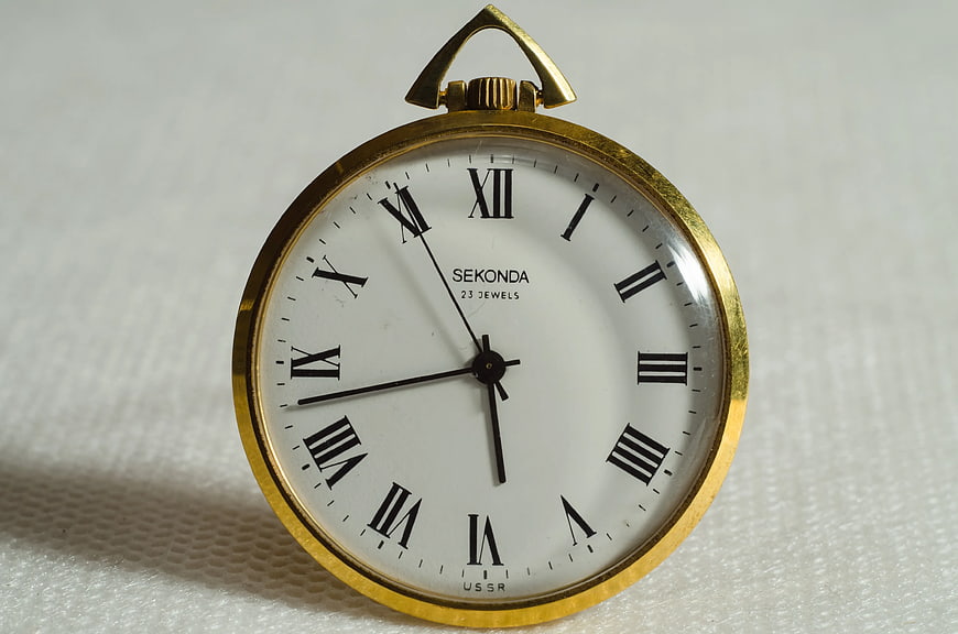 Vintage Sekonda Brass Pocket Watch on White Background