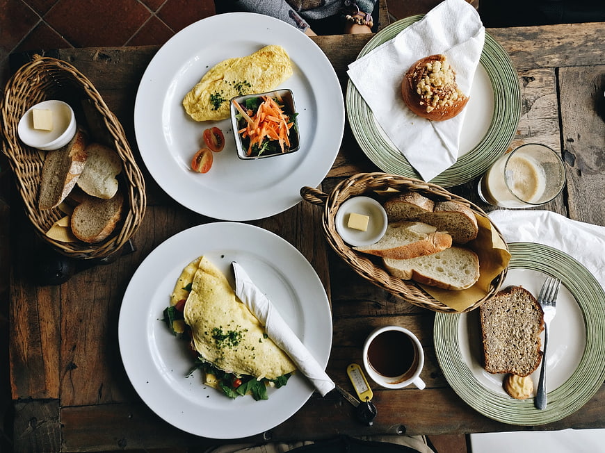 Top view of rustic breakfast with omelettes and bread