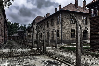 Historic Auschwitz I Concentration Camp Barracks and Barbed Wire Fence