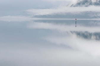Serene Misty Lake with Foggy Mountain Reflections