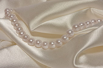 Elegant Pearl Necklace on Cream Silk Fabric