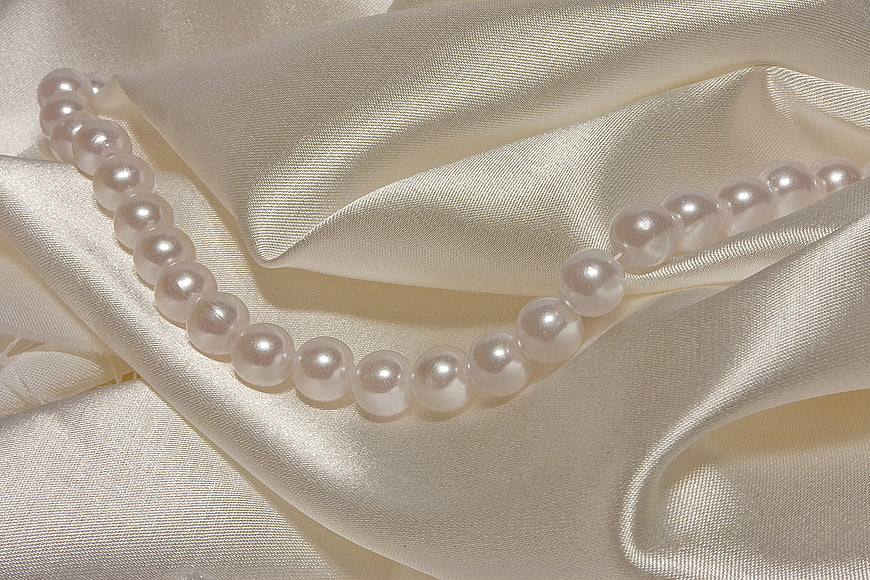 Elegant Pearl Necklace on Cream Silk Fabric