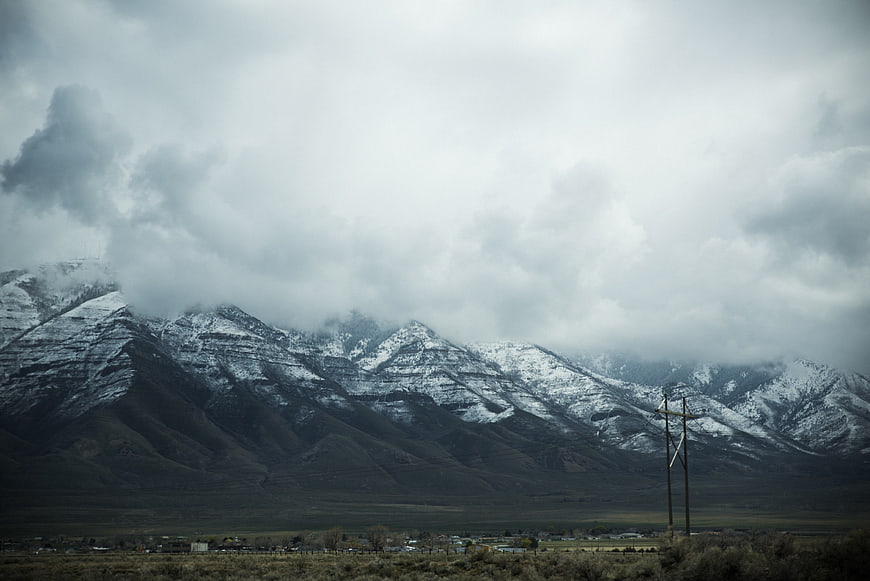 Snow-Capped Mountains Under Dramatic Cloudy Sky