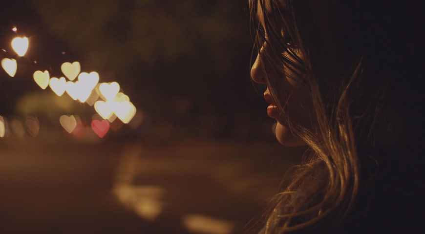 Woman in Profile with Heart-Shaped Bokeh Lights at Night