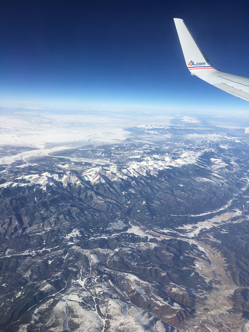 Aerial View of Snow-Covered Mountains from Airplane Window
