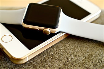 Gold Apple Watch and iPhone on Textured Surface