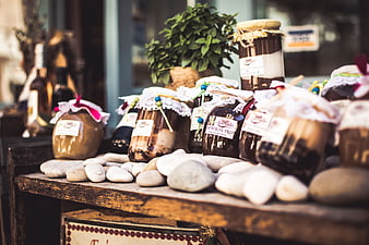 Artisanal jars of honey and preserves on rustic wooden table