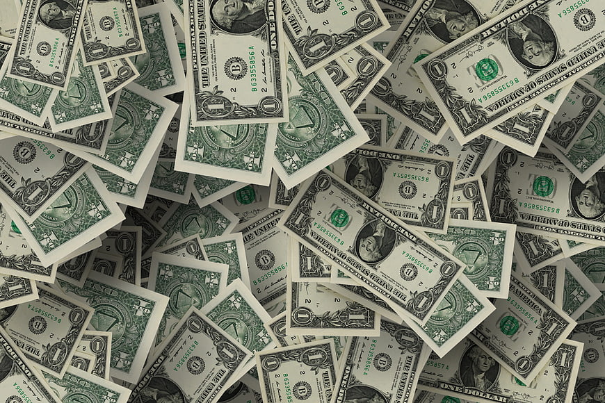 Scattered pile of one dollar bills background texture