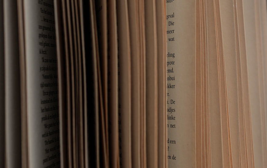 Close-up of open book pages with blurred text