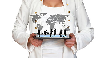Businesswoman holding tablet with global network map