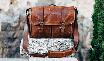 Vintage Brown Leather Messenger Bag On Stone Block