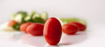Fresh Red Cherry Tomato on White Plate with Salad