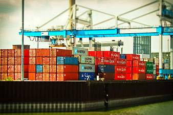 Tilt-shift view of colorful shipping containers at a busy port