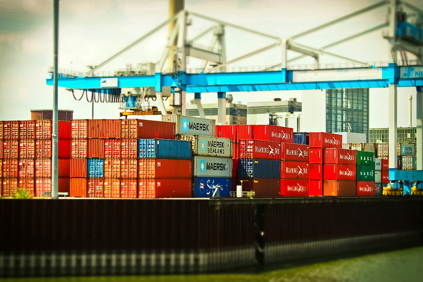 Tilt-shift view of colorful shipping containers at a busy port