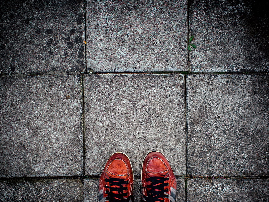 Top View of Red Sneakers on Concrete Pavement