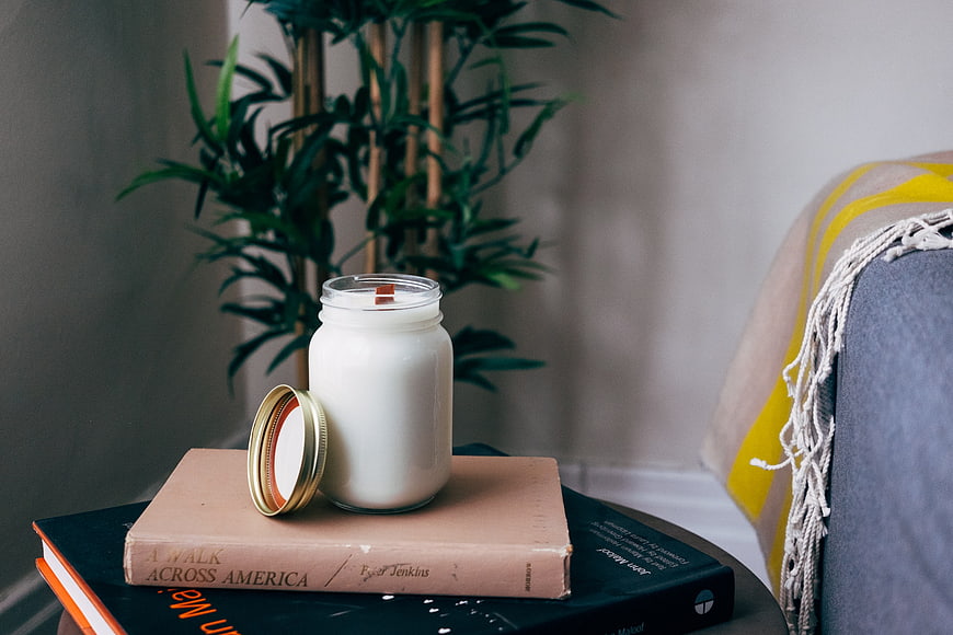 Cozy Home Interior with Candle, Books, and Plant