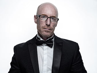 Bald Man In Black Tuxedo And Glasses Studio Portrait